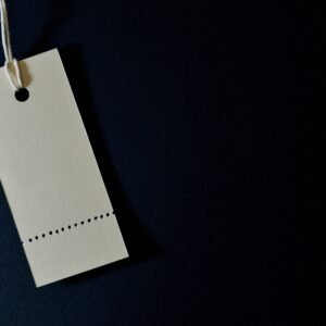 Elegant minimalist card with a string, ideal for labeling or pricing against a black background.